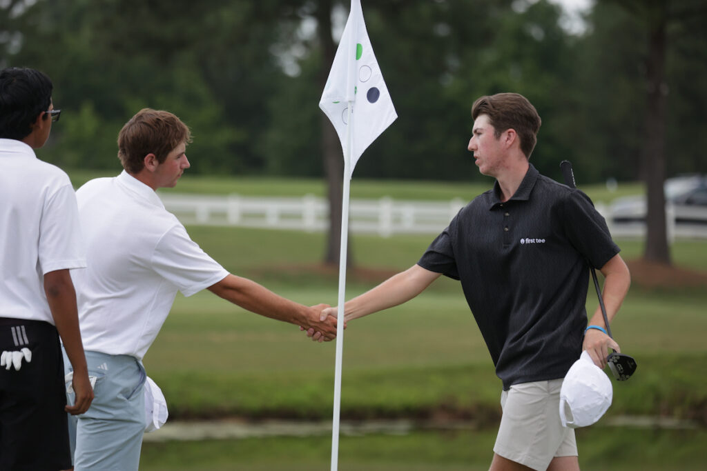 Two participants at the First Tee National Championship shake hands after final putts.